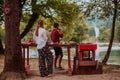 Happy couple toasting red wine glass while having picnic french dinner party outdoor during summer holiday vacation near Royalty Free Stock Photo