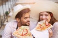 Couple of tourist eating pizza on street Royalty Free Stock Photo