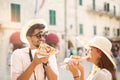 Couple of tourist eating pizza on street Royalty Free Stock Photo