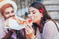 Couple of tourist eating pizza on street Royalty Free Stock Photo