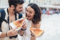 Couple of tourist eating pizza on street Royalty Free Stock Photo