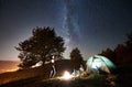 Couple tourists resting at night camping under stars Royalty Free Stock Photo