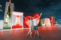 Couple tourists hugging and enjoys their journey near the caption I love Dubai at night. Sightseeing attractions in UAE Royalty Free Stock Photo