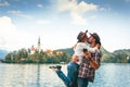 Happy couple of tourists in love is kissing on the background with Bled Lake and Church on the Island, Slovenia. Summer time in Royalty Free Stock Photo