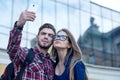 Happy couple of tourists taking selfie in showplace of city Royalty Free Stock Photo