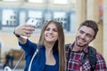Happy couple of tourists taking selfie in showplace of city Royalty Free Stock Photo