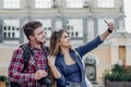 Happy couple of tourists taking selfie in showplace of city Royalty Free Stock Photo