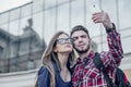 Happy couple of tourists taking selfie in showplace of city Royalty Free Stock Photo