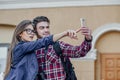 Happy couple of tourists taking selfie in showplace of city. Man and woman making photo on city background Royalty Free Stock Photo