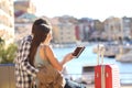 Happy couple of tourists using a tablet on vacation