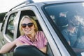 Happy couple travel by car in countryside. Young cool people on adventure road trip in mountains. Man and woman on escape romantic Royalty Free Stock Photo