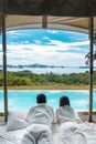 Happy Couple traveler enjoy Beautiful ocean view, Tourists relaxing in tropical luxury resort with swimming pool.Together, Royalty Free Stock Photo