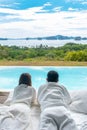 Happy Couple traveler enjoy Beautiful ocean view, Tourists relaxing in tropical luxury resort with swimming pool.Together, Royalty Free Stock Photo