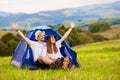 Happy couple traveler with hands up against background of mountains. Camping, travel, lifestyle resting, relaxing concept Royalty Free Stock Photo