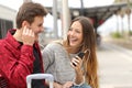 Happy couple of travelers sharing music on holidays