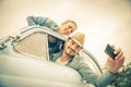 Happy couple travelling on a vintage car Royalty Free Stock Photo