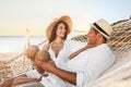 Happy couple with tropical cocktails relaxing in hammock Royalty Free Stock Photo