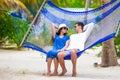 Happy couple on tropical vacation relaxing in hammock Royalty Free Stock Photo
