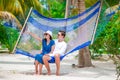 Happy couple on tropical vacation relaxing in hammock Royalty Free Stock Photo