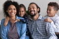 Happy couple with two funny adorable kids having fun together Royalty Free Stock Photo