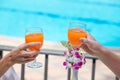 Happy couple with two glasses of orange juice at swiming pool vacation Royalty Free Stock Photo