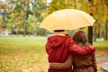 Happy couple with umbrella walking in autumn park Royalty Free Stock Photo