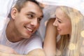 Happy couple under blanket in bed Royalty Free Stock Photo
