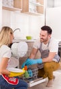 Happy couple unloading dishwasher Royalty Free Stock Photo