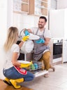 Happy couple unloading dishwasher Royalty Free Stock Photo