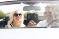 Happy couple usin gps navigation system in car Royalty Free Stock Photo