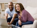 Happy couple using credit card to shop online