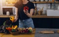 Happy couple using laptop computer preparing healthy food diet vegetable salad at home together. Woman and man are searching Royalty Free Stock Photo