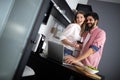 Happy couple using laptop while having breakfast in kitchen Royalty Free Stock Photo