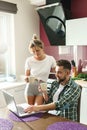 Happy couple using laptop in the kitchen at morning Royalty Free Stock Photo