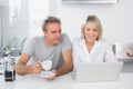 Happy couple using laptop in the morning Royalty Free Stock Photo