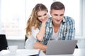 Happy couple using laptop and surfing in internet Royalty Free Stock Photo