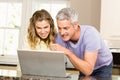 Happy couple using laptop together Royalty Free Stock Photo