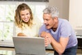 Happy couple using laptop together Royalty Free Stock Photo