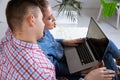 Happy couple using laptop together online. Royalty Free Stock Photo