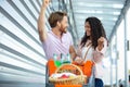 happy couple using shopping cart Royalty Free Stock Photo