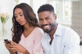 Happy couple using their phones at breakfast Royalty Free Stock Photo