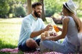 Happy couple on vacation. Lovers enjoy each other in the park, picnic Royalty Free Stock Photo