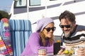 Happy couple of van camper tourist traveler enjoy time together using mobile phone to plan road trip and next destination. People