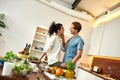 Happy couple, vegetarians looking into each other eyes before preparing a healthy meal in the kitchen together Royalty Free Stock Photo