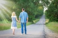 A Happy couple walking along the road in the park in nature travel tourist