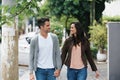 Happy couple, walking and holding hands in city with love and bonding together on vacation in outdoor. Husband, wife and Royalty Free Stock Photo