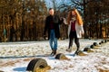 Happy Couple Walking Through The Park On A Sunny Winter Day Royalty Free Stock Photo