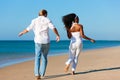 Happy couple walking and running on beach Royalty Free Stock Photo