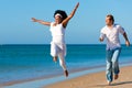 Happy couple walking and running on beach Royalty Free Stock Photo