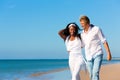 Happy couple walking and running on beach Royalty Free Stock Photo